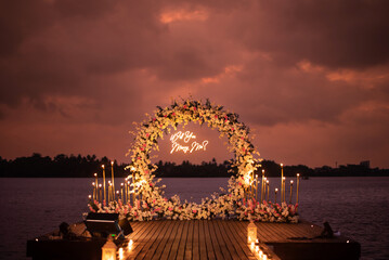 Will you marry me light decoration with flower decoration landscape during a sunset