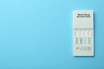 Multi-drug screen test on light blue background, top view. Space for text