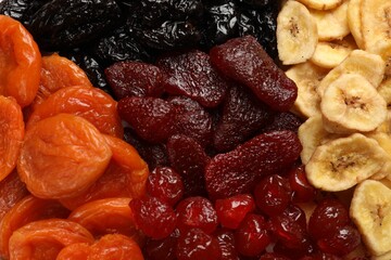 Different delicious dried fruits as background, top view