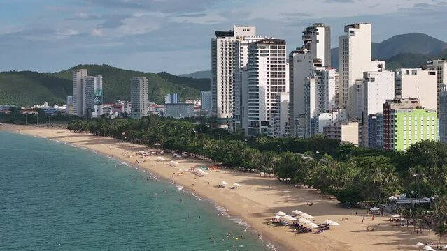 Aerial video of the beautiful coastal city of Nha Trang, with high-rise buildings and cultural buildings. Famous tourist destination of Vietnam