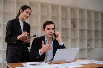 Business team meeting discussion and startup concept. Coworking team meeting. Group of two businesspeople working with new startup project in office