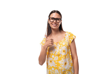 a young woman dressed in a yellow sundress wears glasses for vision correction