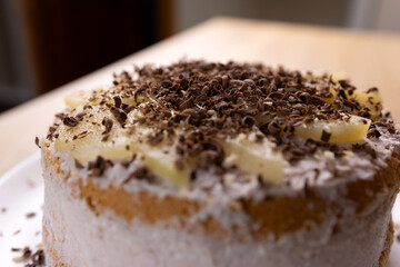 The cake is decorated with pear slices and chocolate. Making cakes.