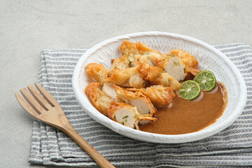 Batagor, made from fish or chicken dumpling, tofu, tapioca flour served with peanut sauce. Indonesian food

