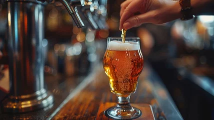 Foto op Canvas hand at beer tap pouring a draught beer in glass serving in a bar © nataliya_ua