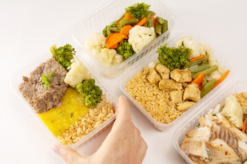 Hands serving packed lunch box home prepared meal in aerial top view close up empty space isolated