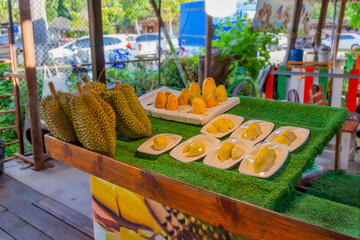 Street stall with exotic fruits Durian and Mango in Thailand. For the convenience of customers, the...