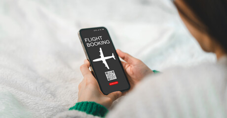 Hand hold smartphone display digital ticketing flight booking application, airplane and scannable...