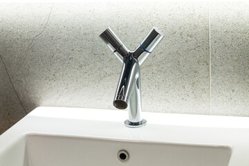 Modern chrome metal faucet and bathroom sink