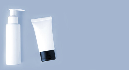 White bottle and tube of cosmetic products background