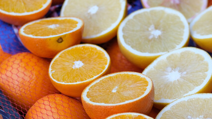 Close up sliced fresh orange and lemon. Fresh C vitamin concept background.