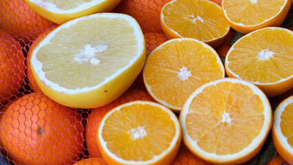 Close up sliced fresh orange and lemon. Fresh C vitamin concept background.