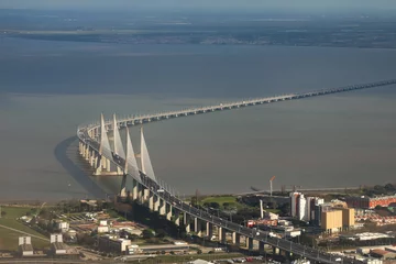 Papier Peint photo autocollant Pont Vasco da Gama Vasco da Gama Bridge from above. Aerial photo with this long cable-stayed bridge, impressive architecture and construction over Tagus river in Lisbon, Portugal.