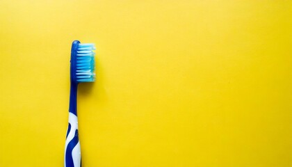 plastic toothbrush on the yellow background with copy space