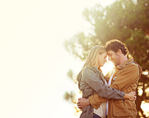 Couple, hug outdoor and sunset in forest, love and peace with trust for commitment in marriage. Partner, nature and people with forehead touch, natural light and mockup space with embrace and support