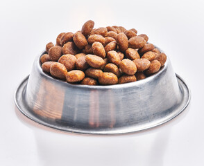  Delicious bowl of dog food balls over isolated white background