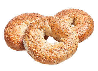 Three sesame bagels with a golden crust isolated on a white background, embodying freshness and bakery quality.