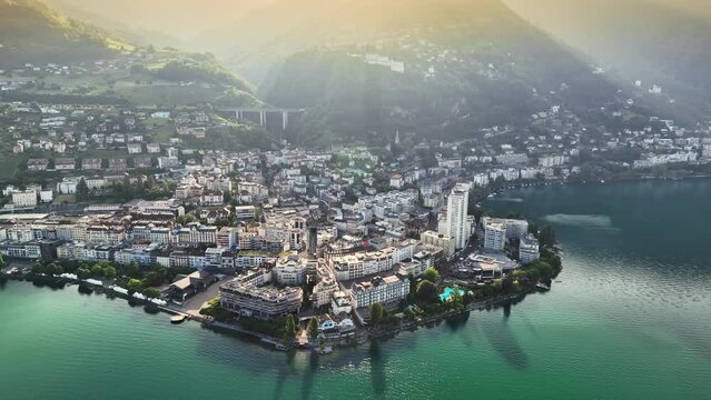 Flying over Lake Geneva, view to Montreux city center and green hills at sunrise. Aerial view of Montreux, Switzerland