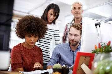 People, creative business and meeting with documents for collaboration, planning or project at office. Group of employees reading with paperwork for teamwork, productivity or startup at the workplace