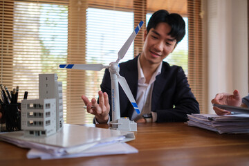 Businesspeople working on a project of alternative energy in the office. Green renewable energy concept.