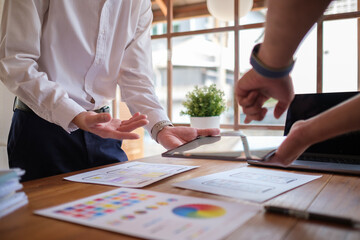 Developer team working together, discussing about Mobile App template design at co working space.