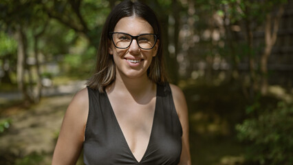 Joyful and confident, a beautiful hispanic woman in glasses stands by the serene ginkaku-ji temple,...