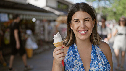 Summertime delight, beautiful hispanic woman enjoying delicious ice cream cone on a sunny day in...