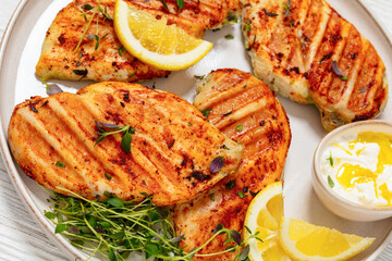 juicy grilled chicken cutlets on plate, top view