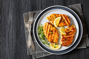 juicy grilled chicken cutlets on plate, top view