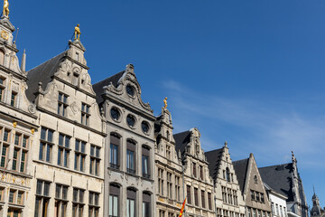 Fototapeta na wymiar Antwerp, Belgium. 15 April 2023. Facades of Antwerp, old historical buildings in the centre of the city. Decorated with golden statues at Grote Markt of Antwerp