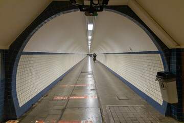 Obraz premium Antwerp, Belgium. 15 April 2023. Sint Annatunnel is a pedestrian and bicycle tunnel under the river Schelde with wooden escalators, this is a 572 meter long tunnel.