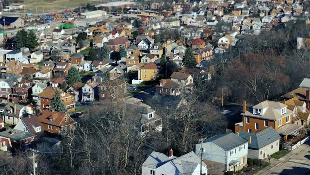 A parallax aerial view of the residential district of a small Western Pennsylvania river town in early Spring. Pittsburgh suburbs.  	