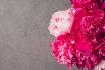 Beautiful bouquet of fresh fluffy peony flowers in full bloom, top view. Negative space for text.