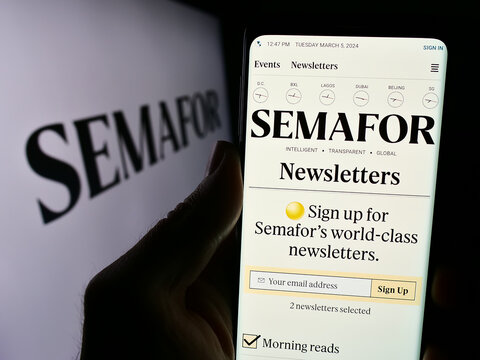 Stuttgart, Germany - 03-05-2024: Person holding cellphone with website of US media company Semafor Inc. in front of business logo. Focus on center of phone display.
