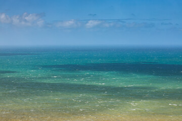 Obraz premium Atlantic Ocean. Photo with the beautiful green blue water landscape of the ocean, the layers of water, during a sunny day at Cabo da Roca in Portugal.