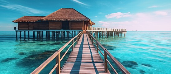 Wooden pier in the sea at Maldives - obrazy, fototapety, plakaty