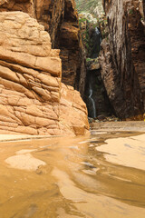 Ursa Beach waterfall at Atlantic Ocean shore. Beautiful photo with a hidden tiny waterfall between the rocks from Cabo da Roca in Portugal.