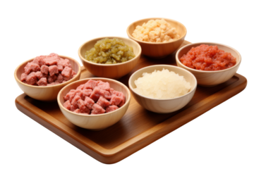 Various forms of agricultural protein such as cubes, minced pork and minced chicken are placed in bowls and lined up on wooden tables. Highlighted variety isolated on transparent background.