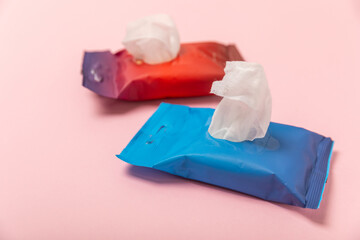 Pack of wet wipes on a pink background. An open pack of hand and body wipes. Mockup. A clean packet...