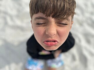 boy making funny faces distorted 