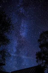 Starry sky with bright stars outside the city in the mountains, no one, the Milky Way. Silhouettes...