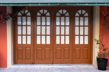 Old wooden door with glass windows in old town in Europe. Entrance of house with arched wooden door and transom window