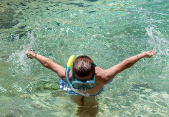 Boy with snorkel and mask explore underwater. Child have fun enjoy nature, swim and dive in...