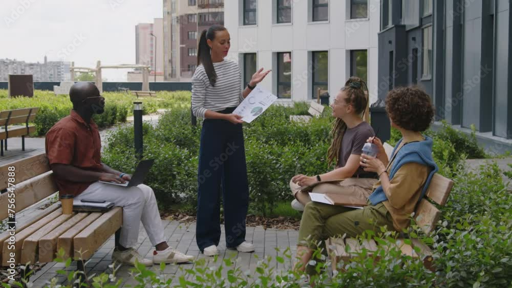 Poster wide footage of business manager explaining financial statistics with chart and diagrams during outd
