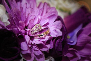 wedding ringing in purple flowers 