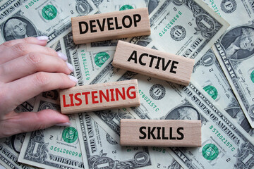Listening skills symbol. Concept word Develop active listening skills on wooden blocks. Beautiful...