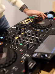 disc jockey playing music with a mixing table