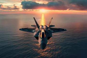 Fotobehang flying over the ocean at sunset jet fighter F35 with great speed. new technologies of military combat aviation concept © Kien