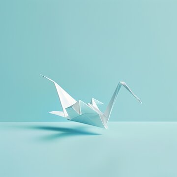 A simple white origami crane positioned against a soft