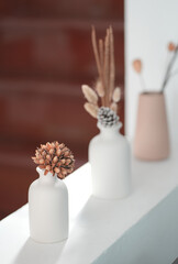 Close up and selective vase of flower on white cement table in living room, copy space concept.	